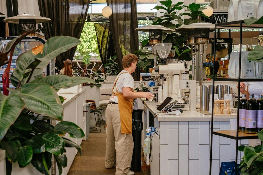 Café interior with a bartender at the bar
